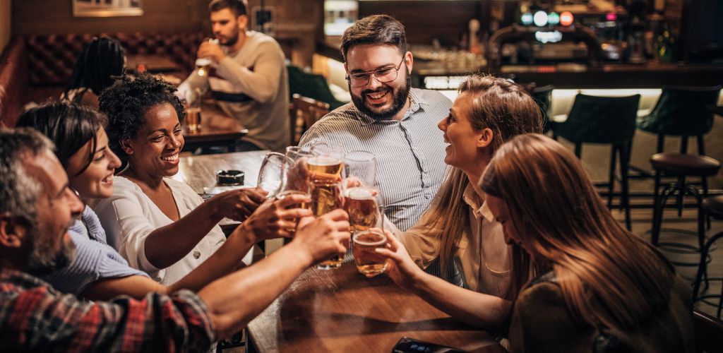 A group of people cheersing and enjoying a nice time on a pub crawl in Tulum