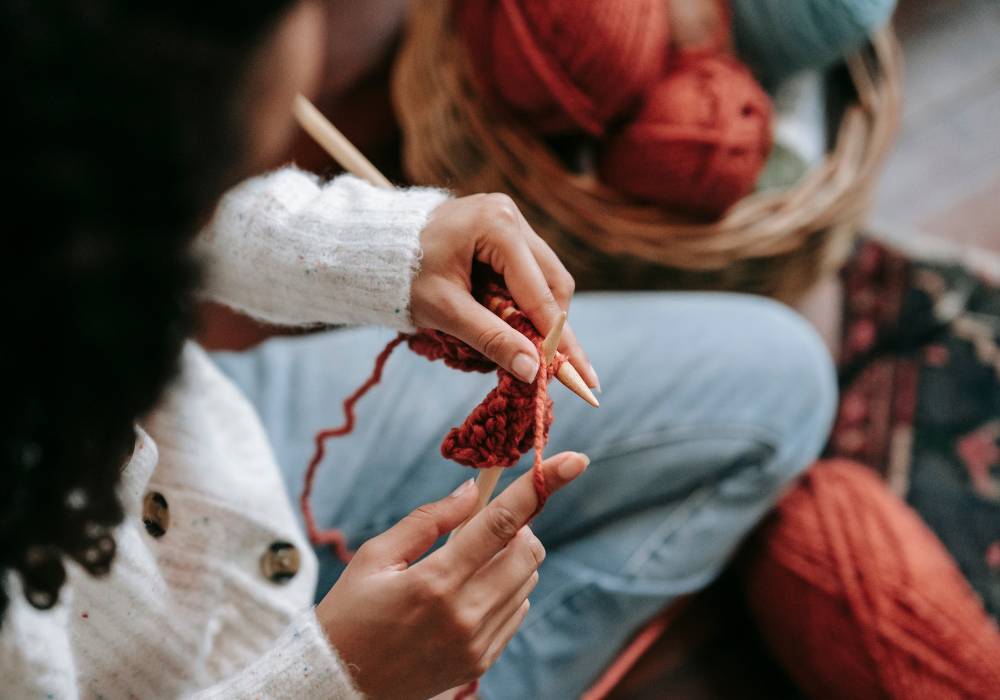 A photo of a woman crocheting up close.