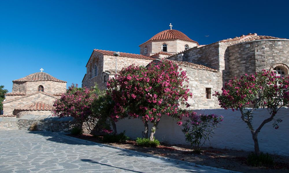 Ekatontapiliani church in paros greece with trees in front