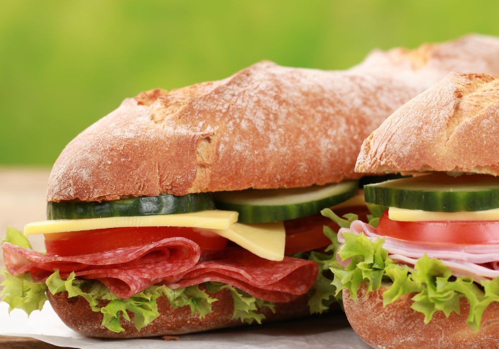 baguettes with pepperoni, ham, cheese, tomatoes, lettuce and cucumber