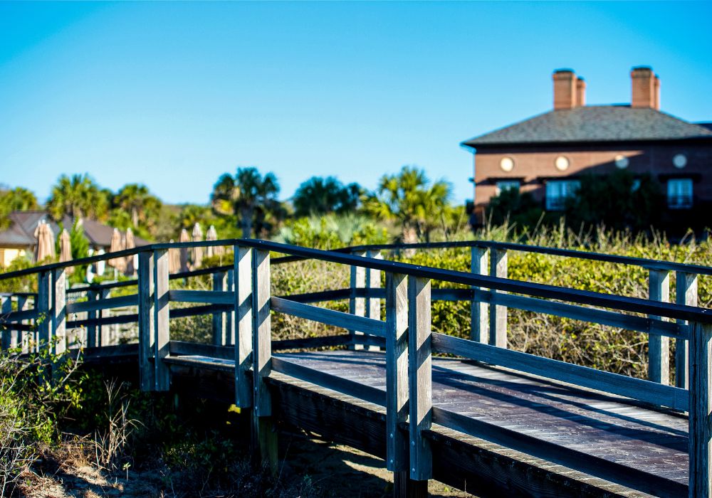 wooden bridge with houses in the background on kiawah island south carolina