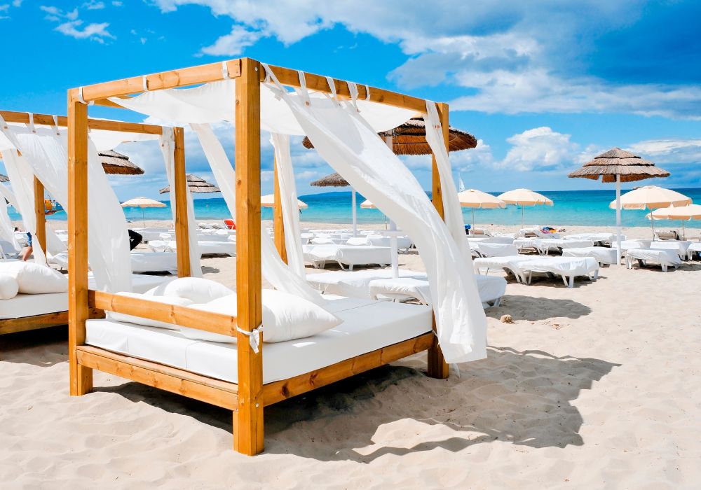 beach beds and chairs on the sand in isla mujeres