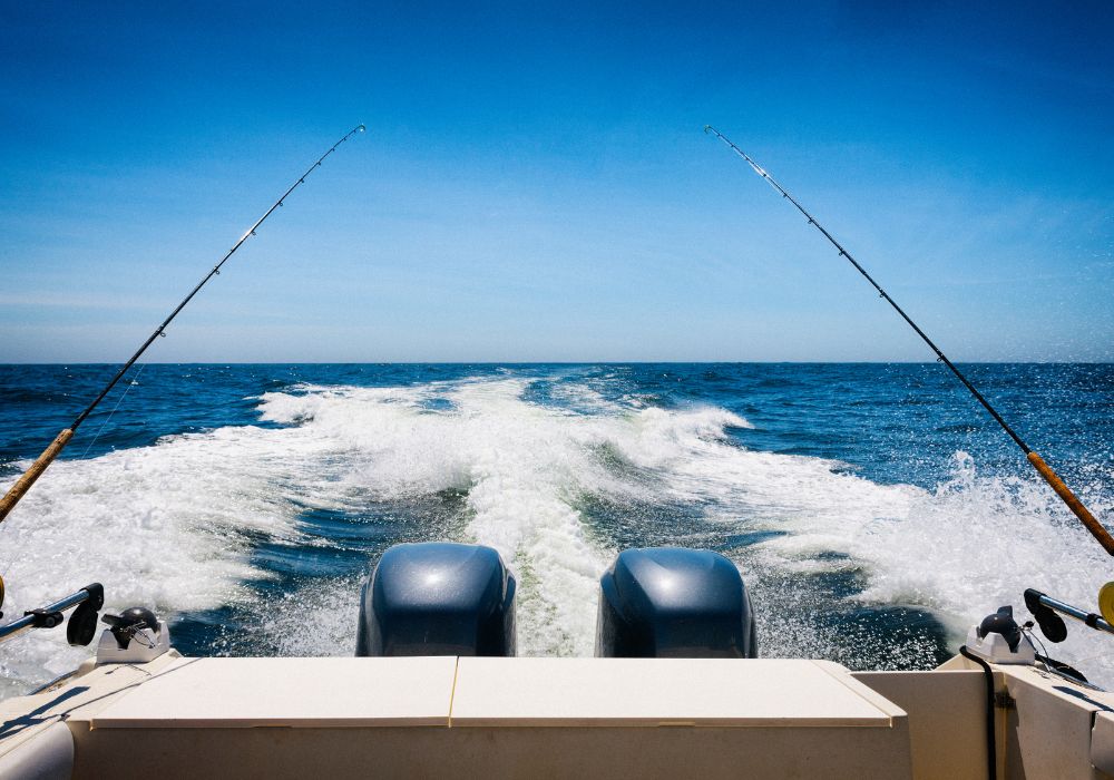 deap sea fishing boat isla mujeres with two fishing rods and motors on the sea