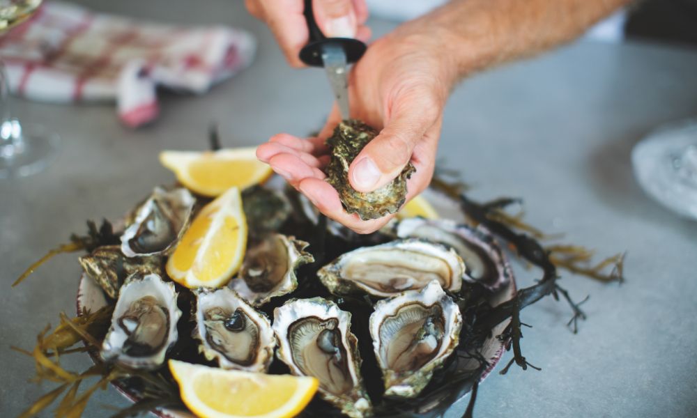 shucking fresh oysters with lemons in mexico