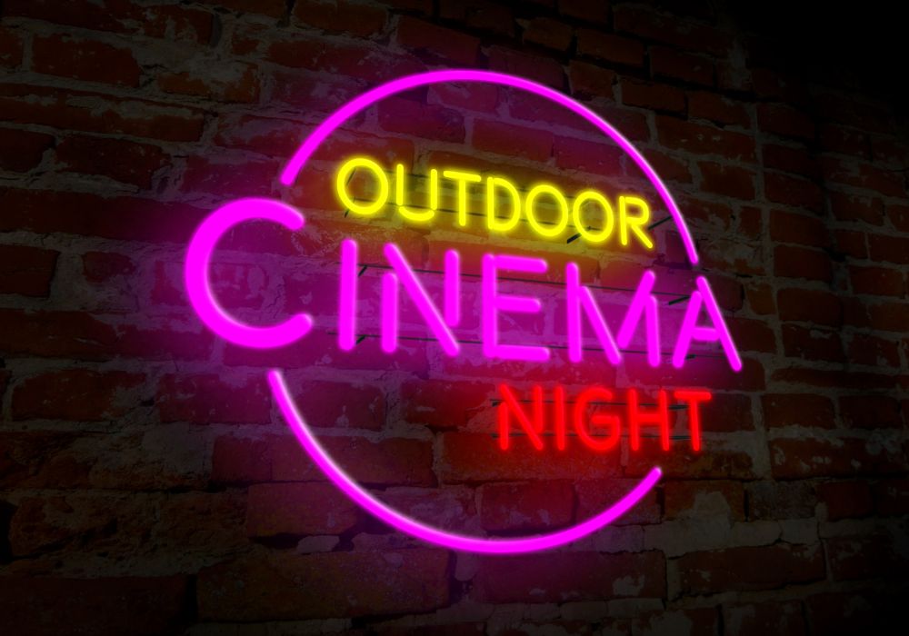 watching movies outside in kiawah island outdoor cinema night sign