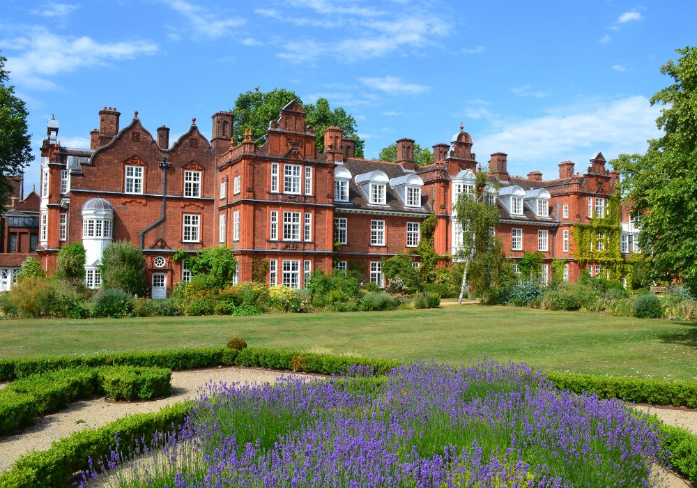 Newnham College Cambridge with lavender and lawn in garden