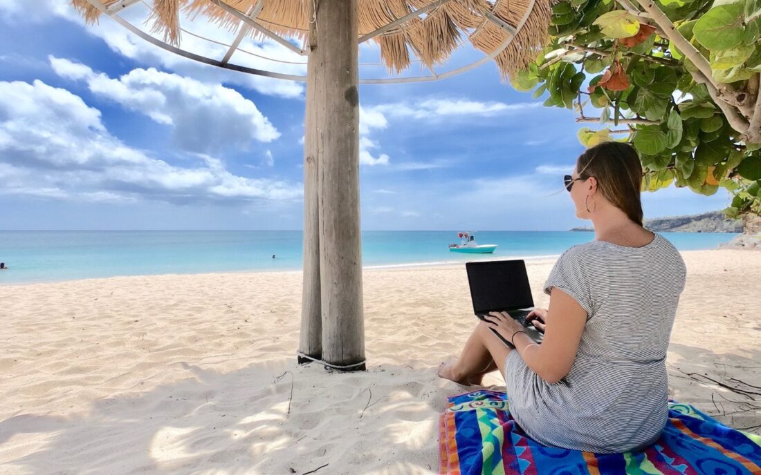 Dariece working remotely from a beach in the Caribbean - feature image