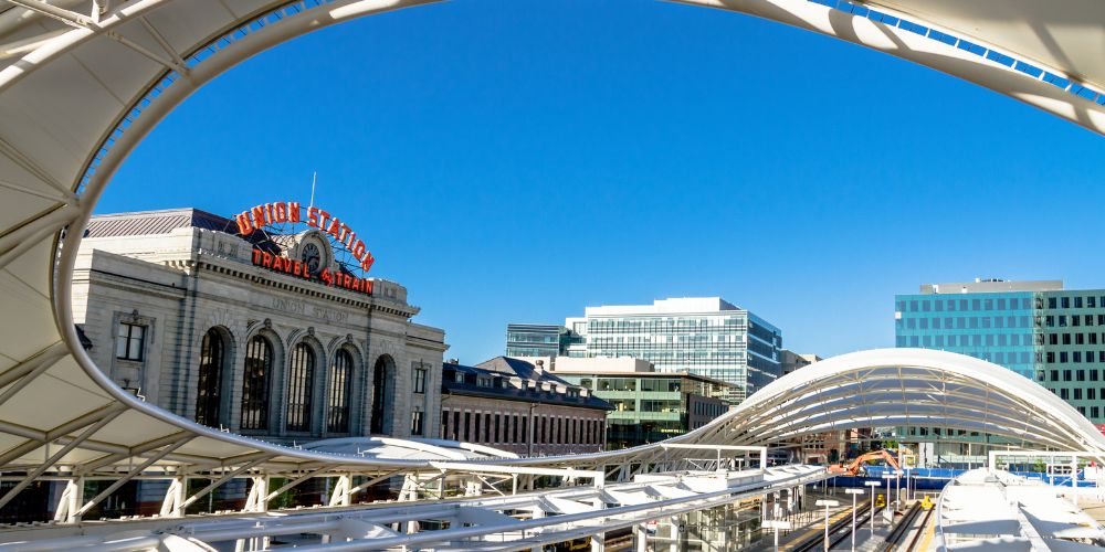 A view of the historic Denver Union Station with modern train platforms in front