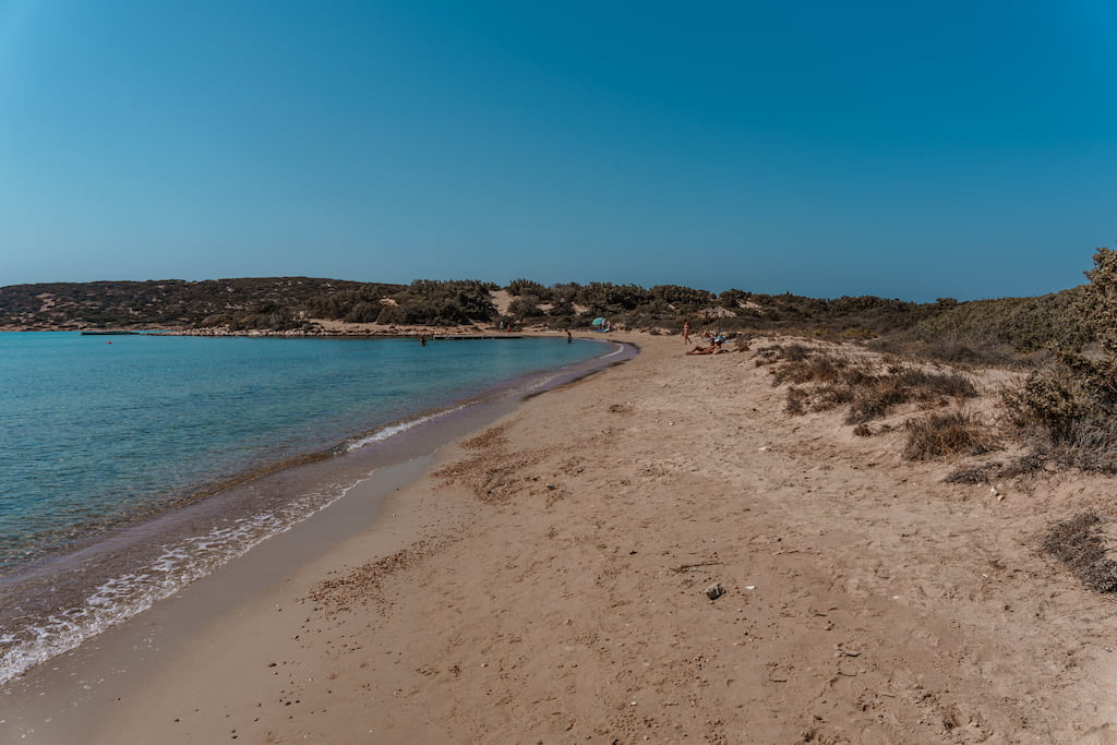 lageri beach in paros greece. empty sandy bay with no chairs and calm water