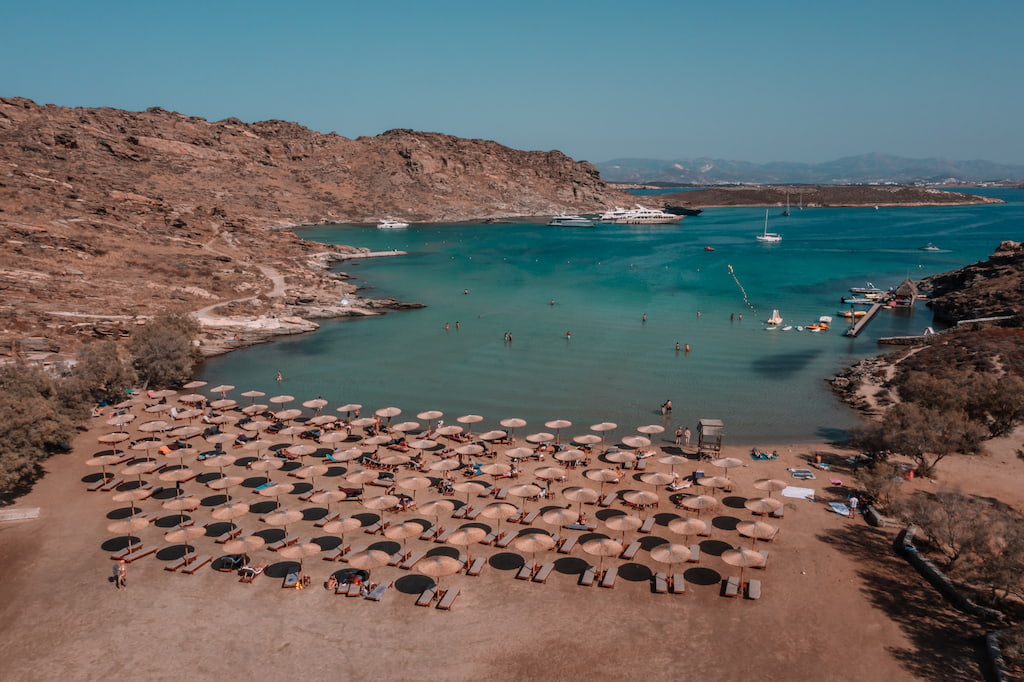 Monastiri beach on paros island in greece small bay with calm blue water and lots of umbrellas and beach loungers