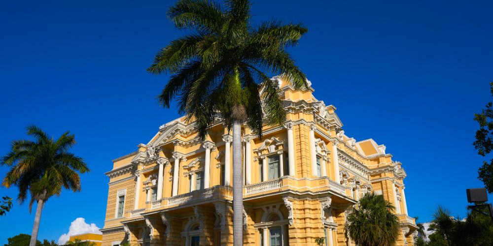 A white and yellow Spanish-colonial mansion on the Paseo de Mantejo in Merida, Mexico