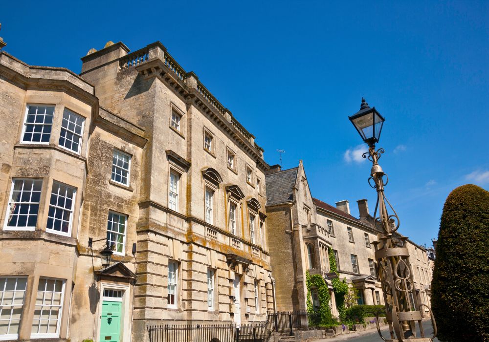 Picturesque Cotswold stone houses on the main street through Painswick, UK