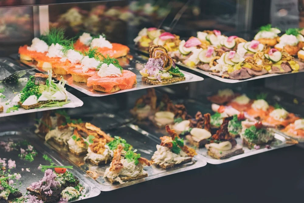 A variety of smørrebrød, open-faced sandwiches, with fish, meat, and more