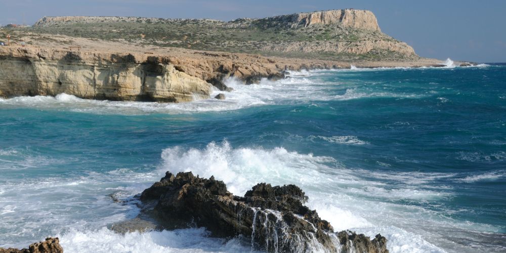 Waves and sandy cliffs at Cape Greco