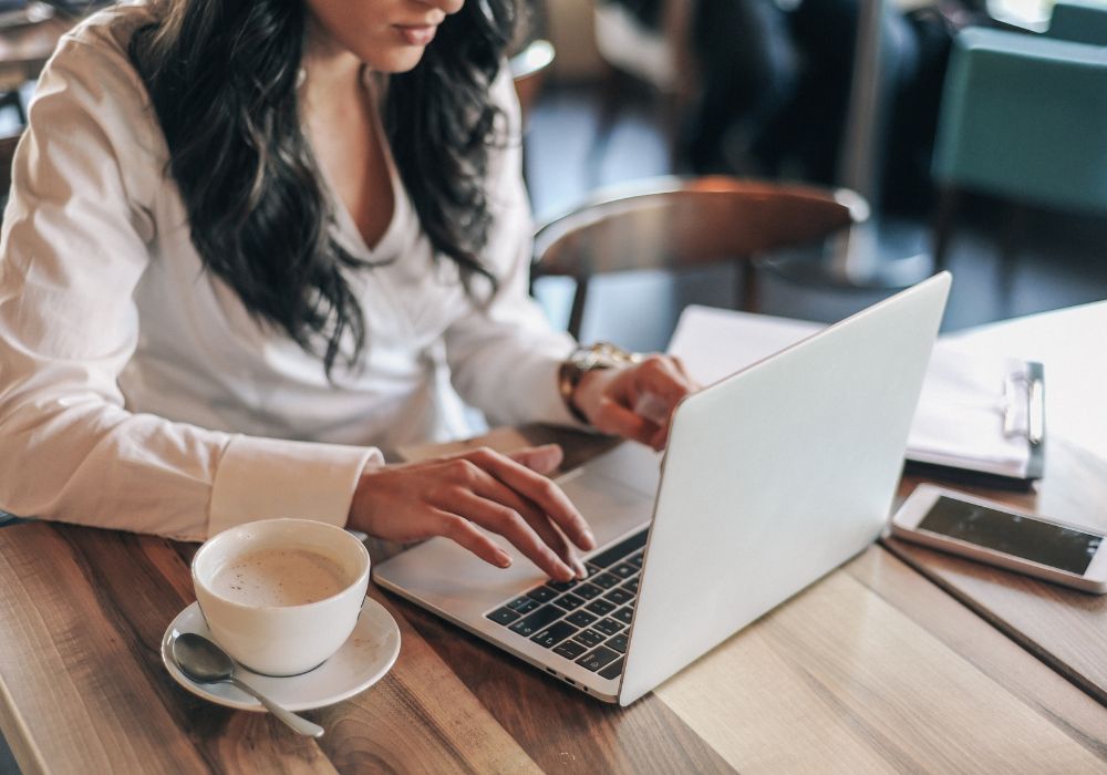 Young digital nomad in cafe working on laptop