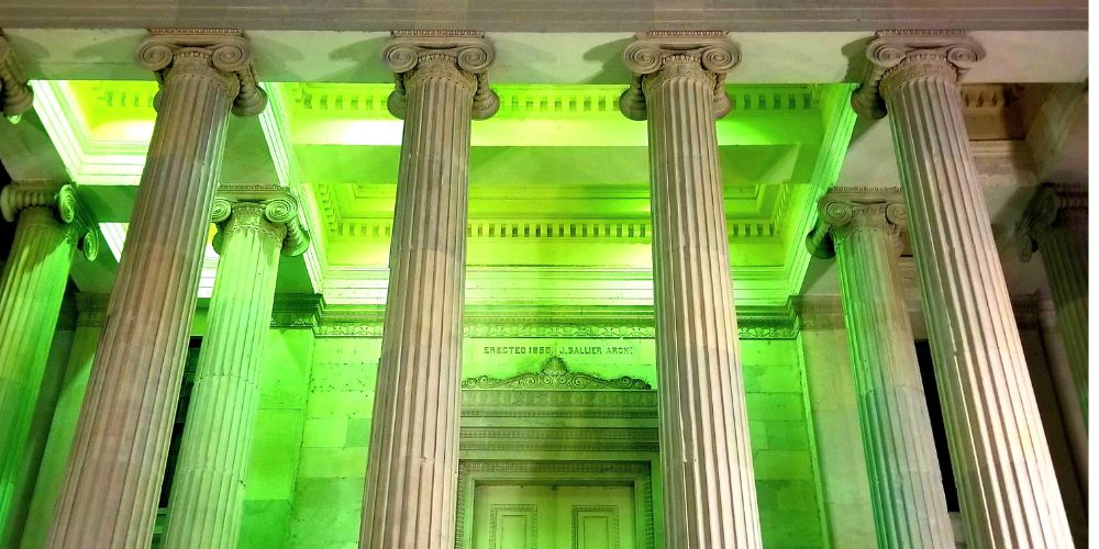 Gallier Hall lit up in green during Luna Fete