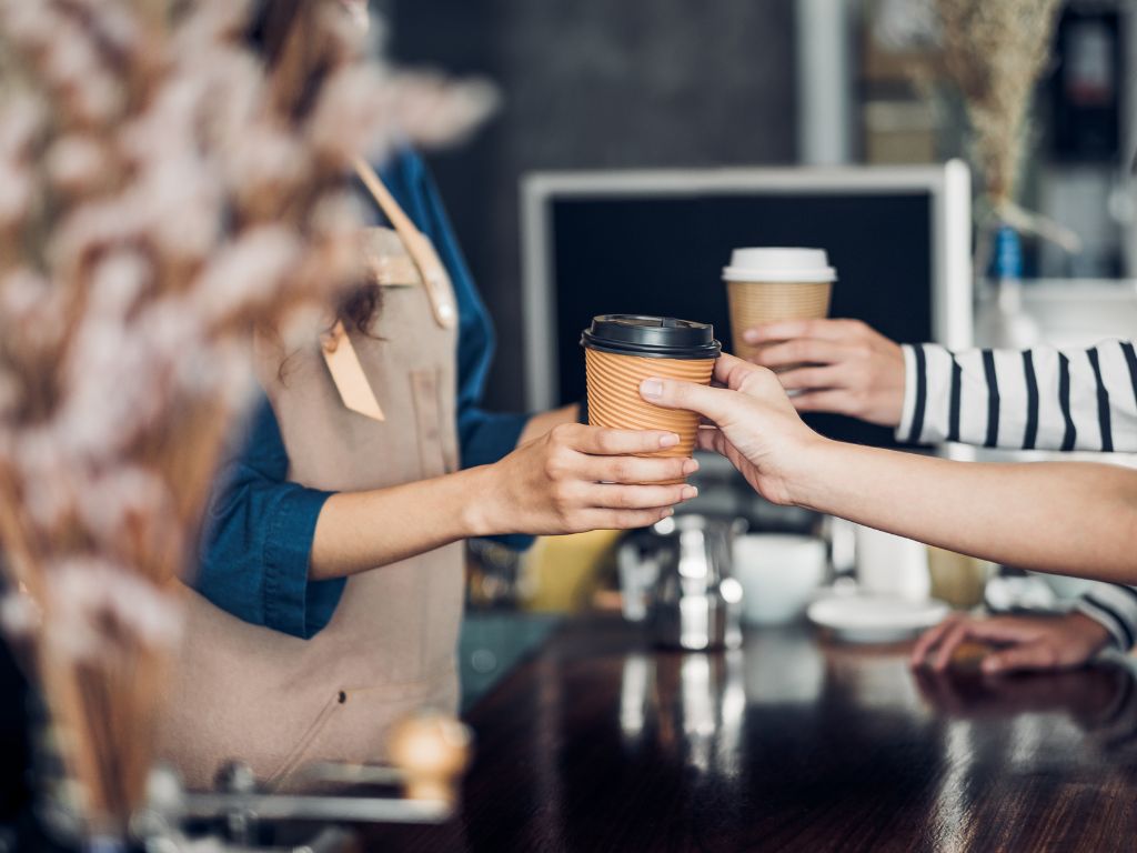 handing coffee to a customer