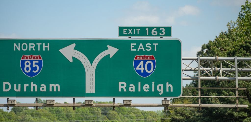 highway sign showing durham to the left and raleigh to the right