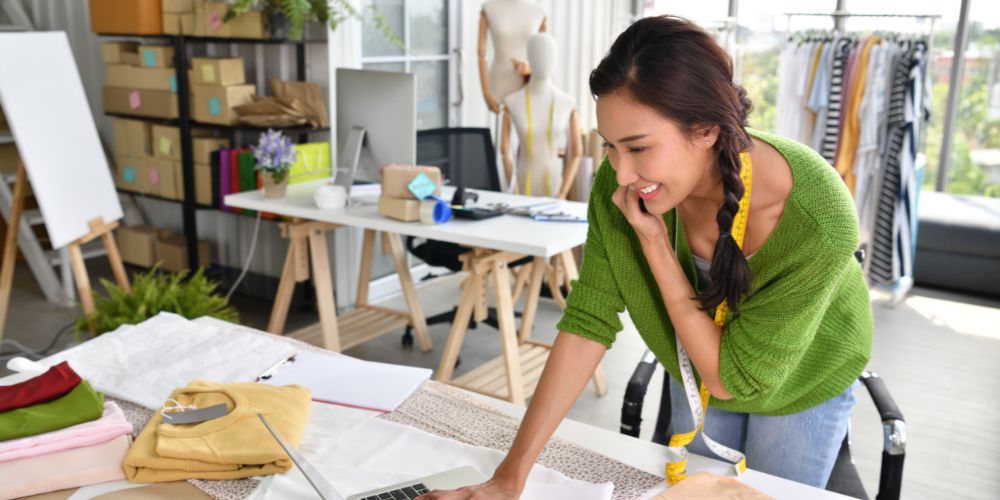 Woman on the phone in a clothing design studio