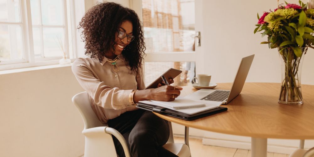 Social media manager working with laptop and smartphone