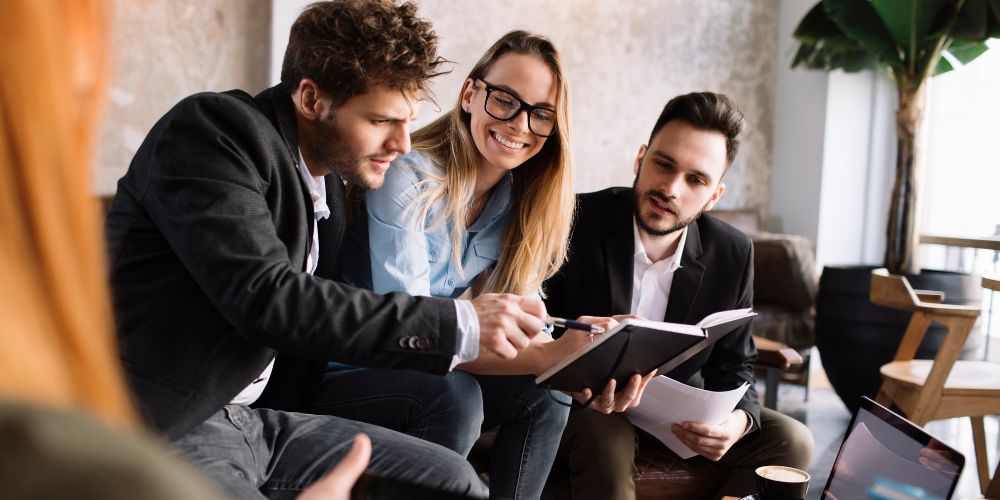 Three people in an informal business meeting