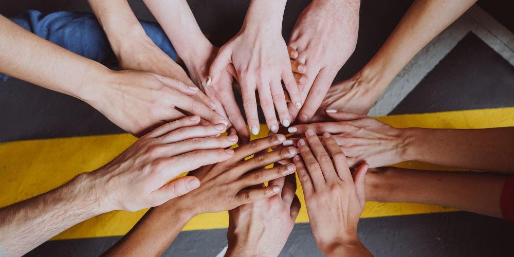 A group of people touching hands