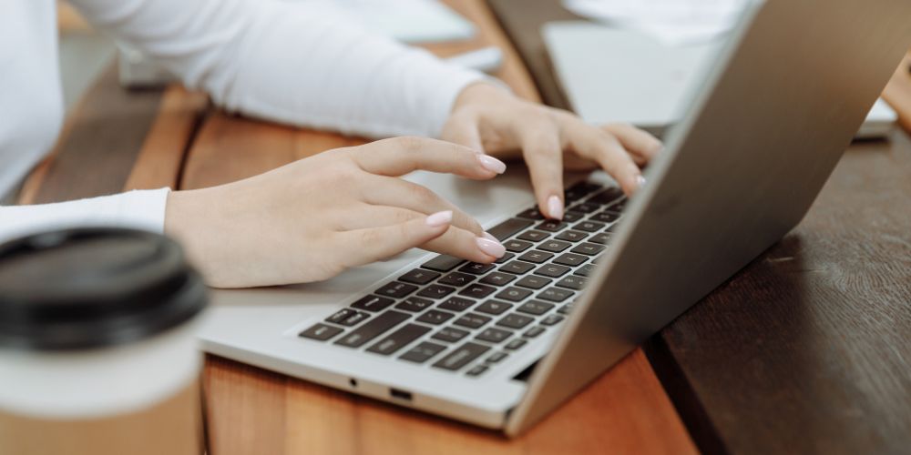 Woman typing on her laptop