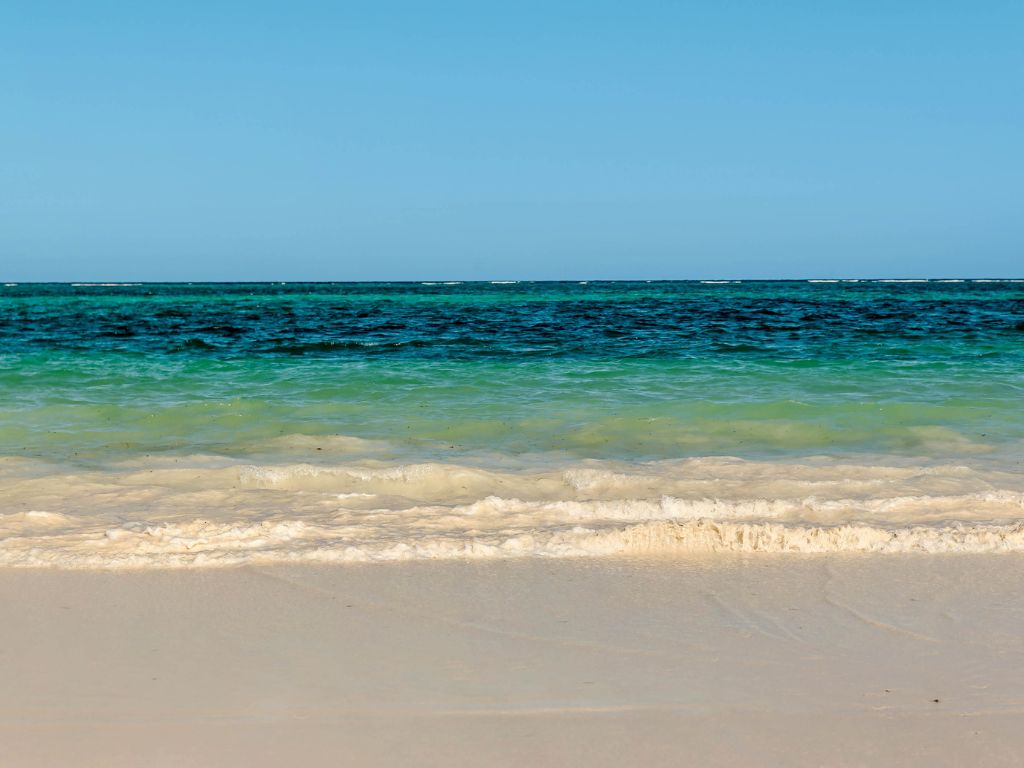 beach with white sand and blue water