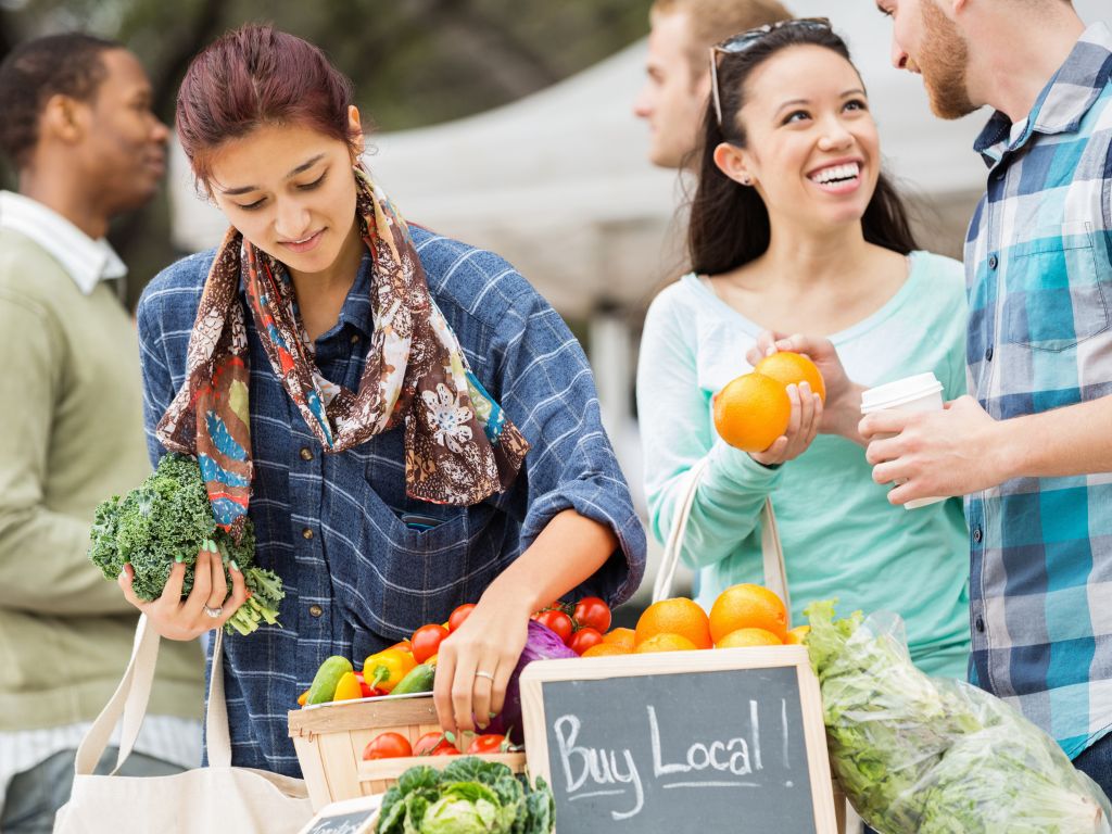 people shopping at a local farmers market