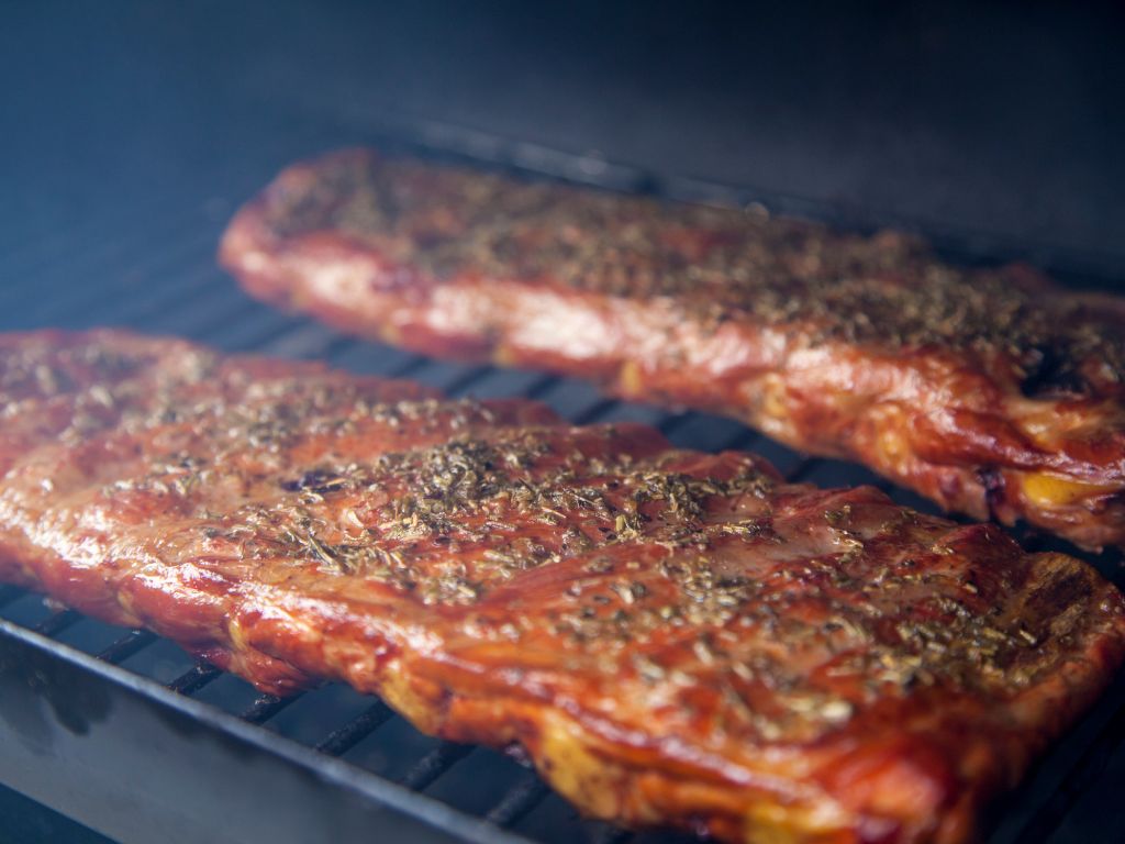 two racks of ribs on a bbq