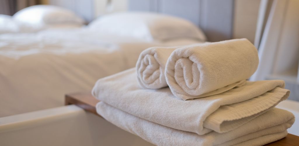 Bed for two  and rolled towels