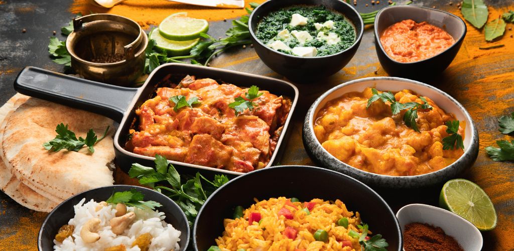 Assorted Indian food on a wooden table