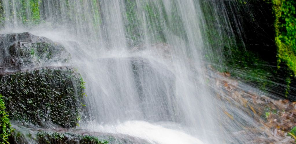 Fairy Glen (Lancashire) water falls into the stones and water splashes beneath