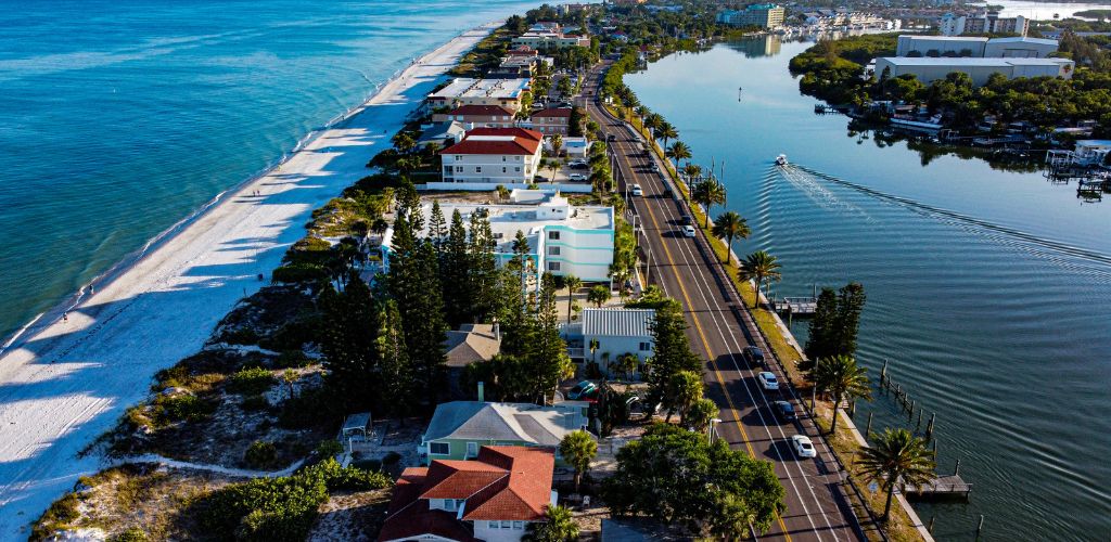 Indian Rocks Beach - aerial view of the resort with water bodies in the left and right side and buildings  beside a highway
