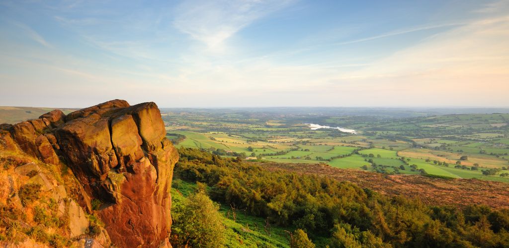 The Roaches (Peak District National Park) A rock in the top of mountain overlooking the fields under it in a sunny weather