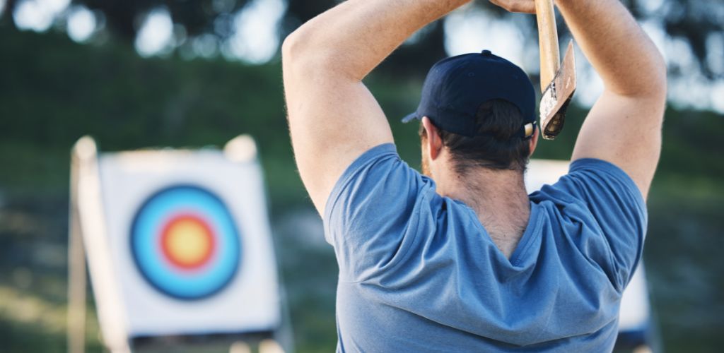 A man throwing axe on a target