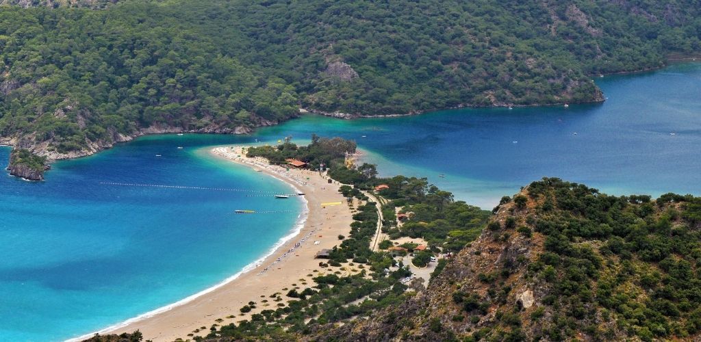 Blue Lagoon, Ölüdeniz. surrounded by mountains and green trees. 