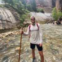 Danny Mooers hiking in a river