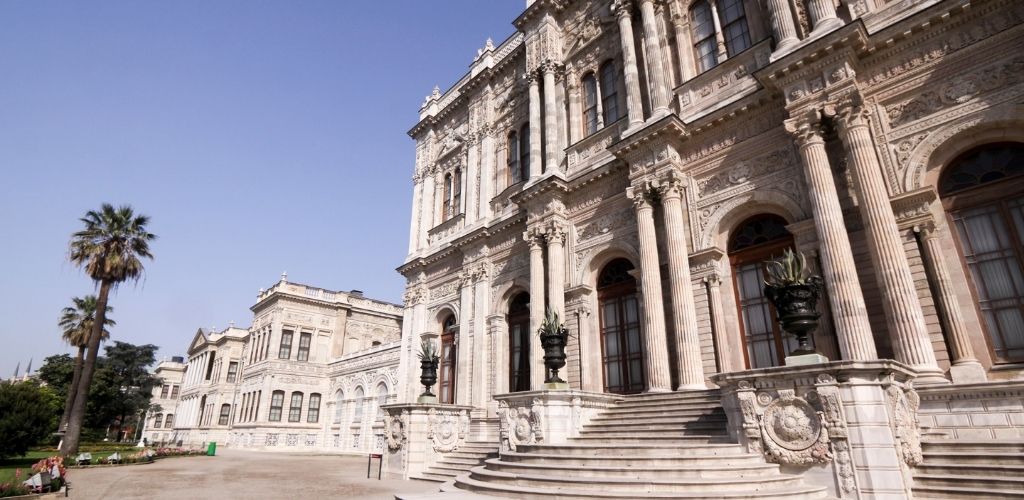 Dolmabahçe Palace in Istanbul, Turkey with trees beside of the palace. 