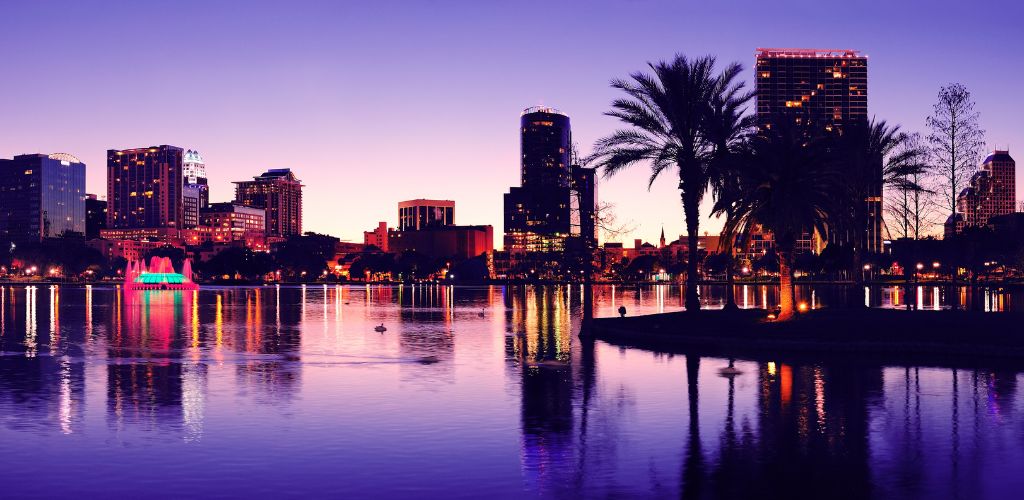 Orlando downtown skyline panorama silhouette over Lake Eola at dusk with urban skyscrapers. 