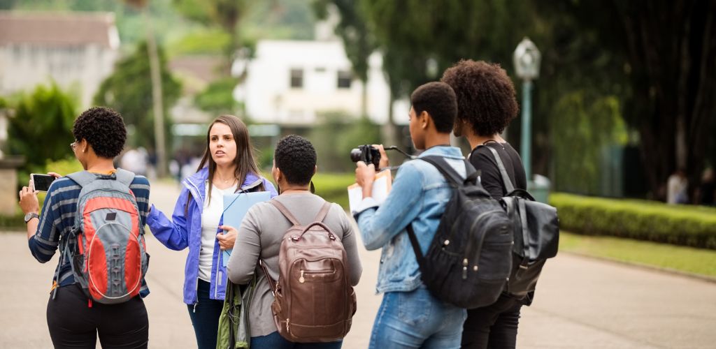 A group of visitors was in the tour guide, and the tour guide guided the travelers. 