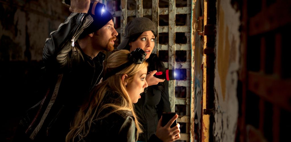 Group of ghost hunters checking out a cell