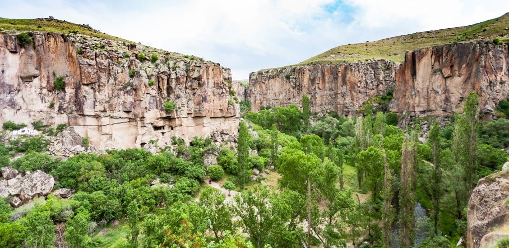 A two beautiful rock mountain and green trees.