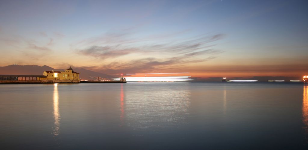 The view of the sea, the structure of the building, and the sunset sky. 
