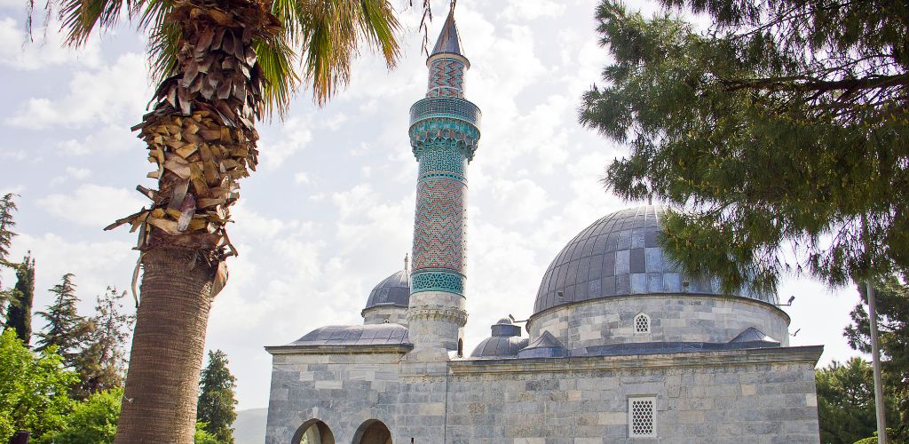 A historic mosque surrounded by trees. 