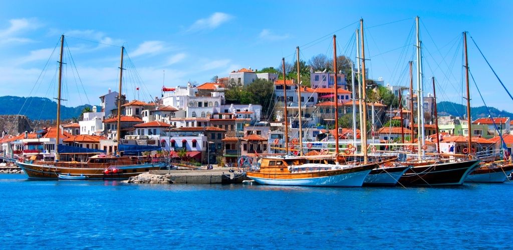 A Yacht and building structures and surrounded by sea water. 