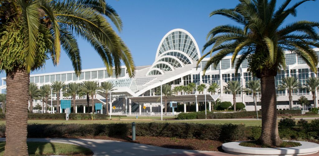 Orange Country Convention Center Orlando Florida showing the unique arch dome of the building surrounded by green plants and trees. 