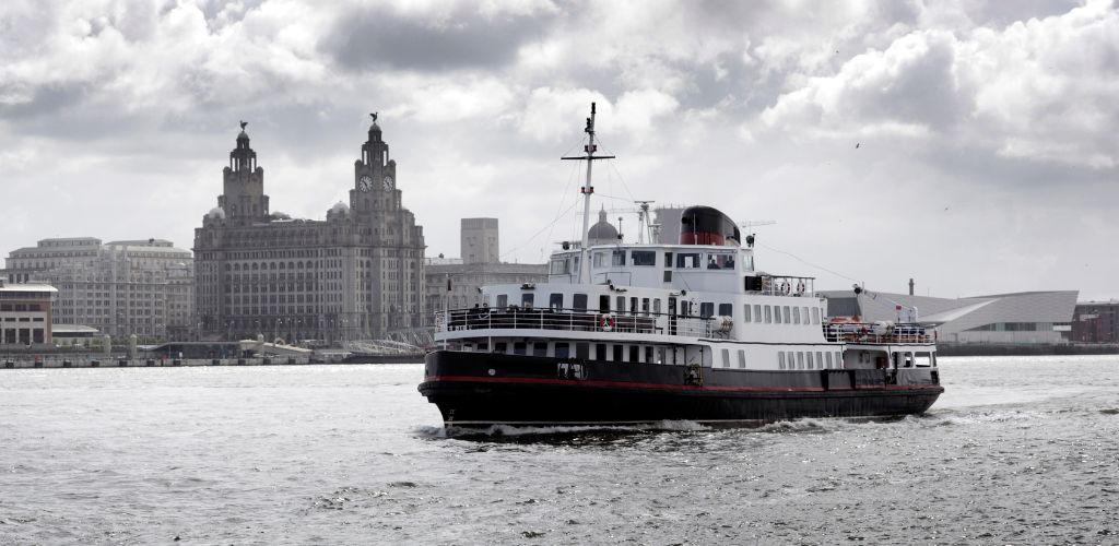 A cruise in River Mersey and a historic structures and building in the background.
