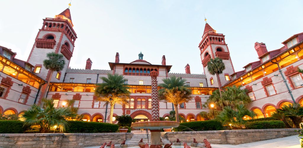 A historic architecture, a miniature fountain, and a landscape with trees. 