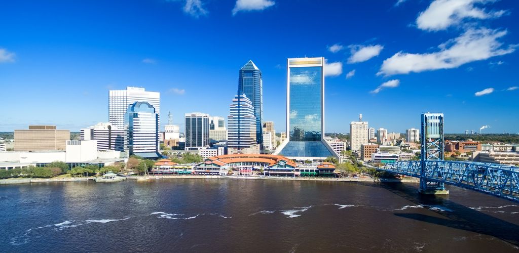 Front view of a river, bridge, and buildings. 